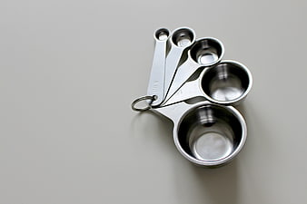 Stainless Steel Measuring Spoons on Gray Background
