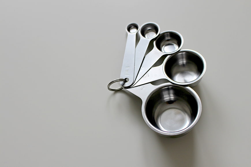 Stainless Steel Measuring Spoons on Gray Background