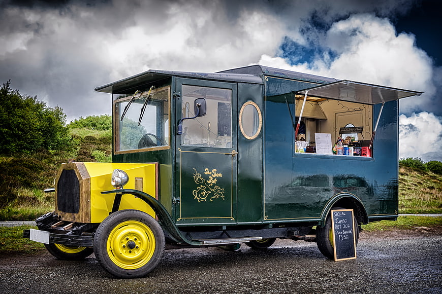 Vintage Green and Yellow Food Truck Parked on Gravel Road