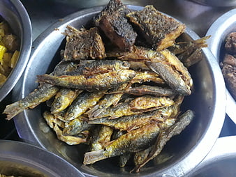 Fried fish and meat in stainless steel bowls