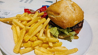 Delicious burger and french fries on a white plate