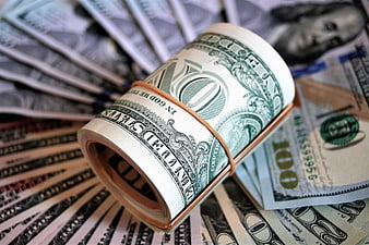 Rolled Bundle Of US One Hundred Dollar Bills On Cash Background