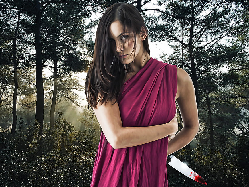 Woman in magenta dress holding bloody knife in dark forest