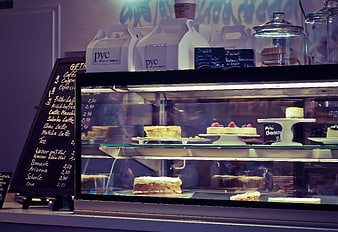 Bakery Display Case With Cakes And Coffee Menu Board