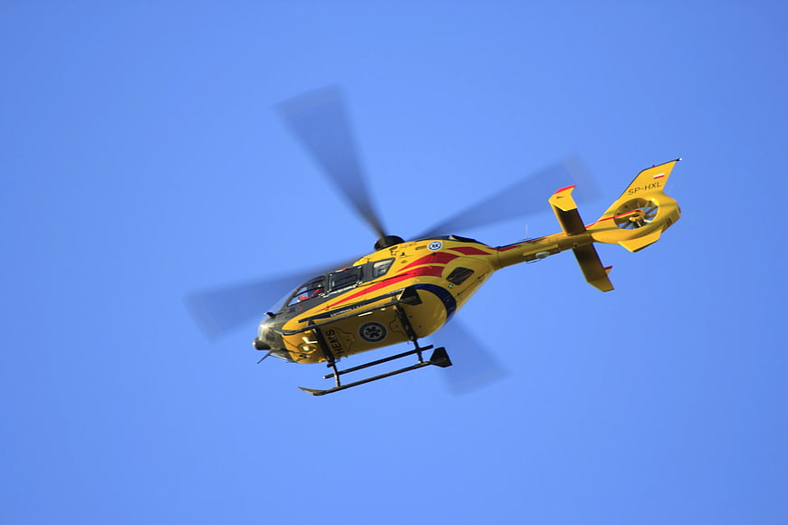Yellow Helicopter Flying Against Blue Sky