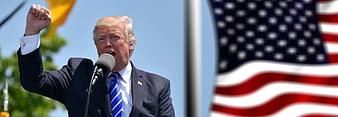 Donald Trump Speaking at Political Rally with American Flag