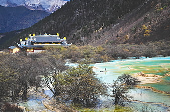 Traditional Chinese Temple Overlooking Turquoise Terraced Pools in Huanglong