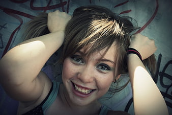 Happy Teenage Girl Smiling with Pigtails in Urban Setting