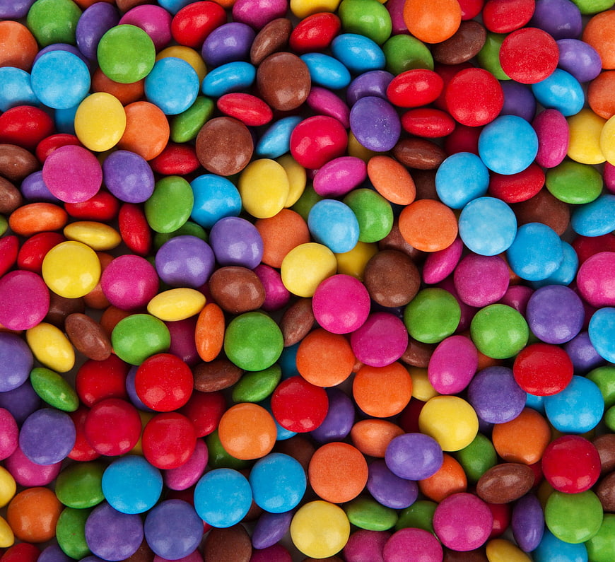 Colorful coated chocolate candies close-up texture background