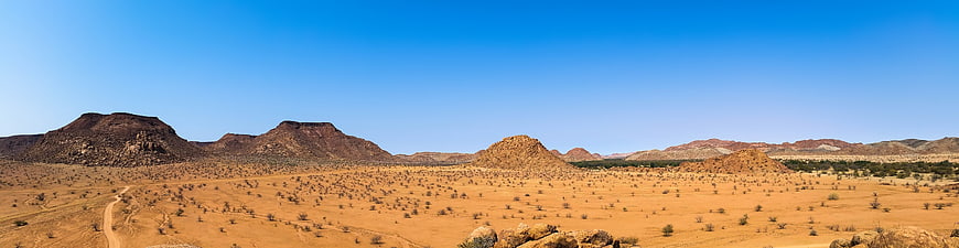 Panoramic View of Arid Desert Landscape with Red Hills