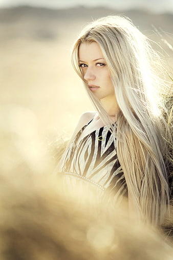 Blonde Woman in Field with Golden Sunlight