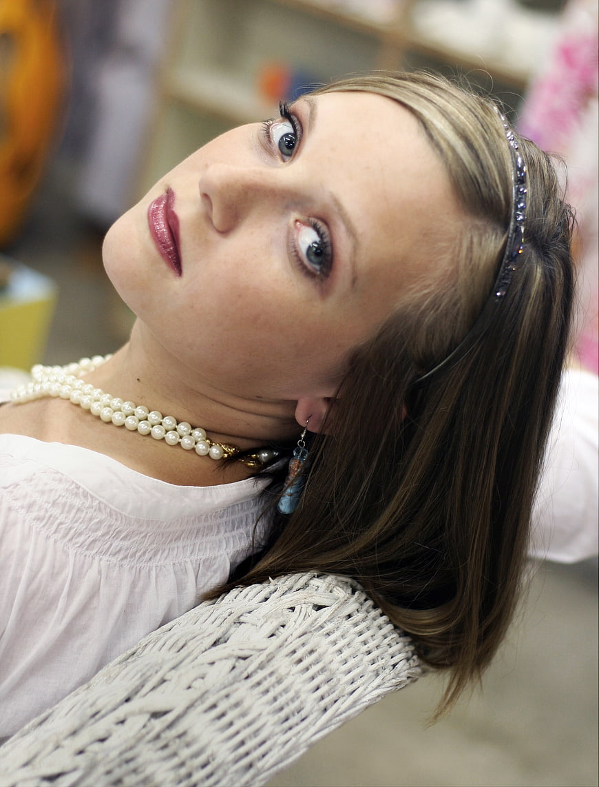 Close-up portrait of woman with pearls and headband