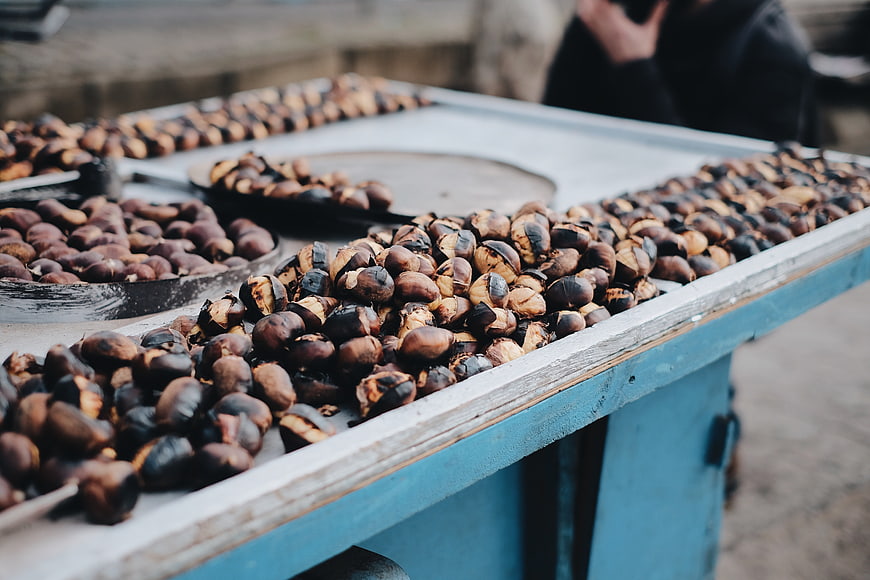 Roasted chestnuts on a wooden street food cart