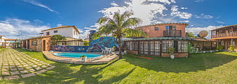 Panoramic view of tropical resort with pool and palm tree