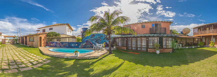 Panoramic view of tropical resort with pool and palm tree
