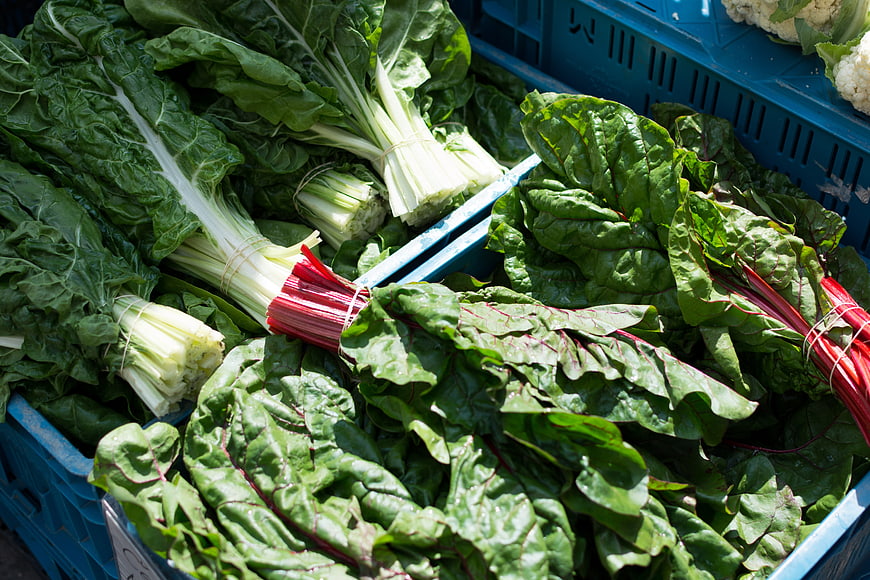 Fresh Swiss Chard and Bok Choy in Blue Crates