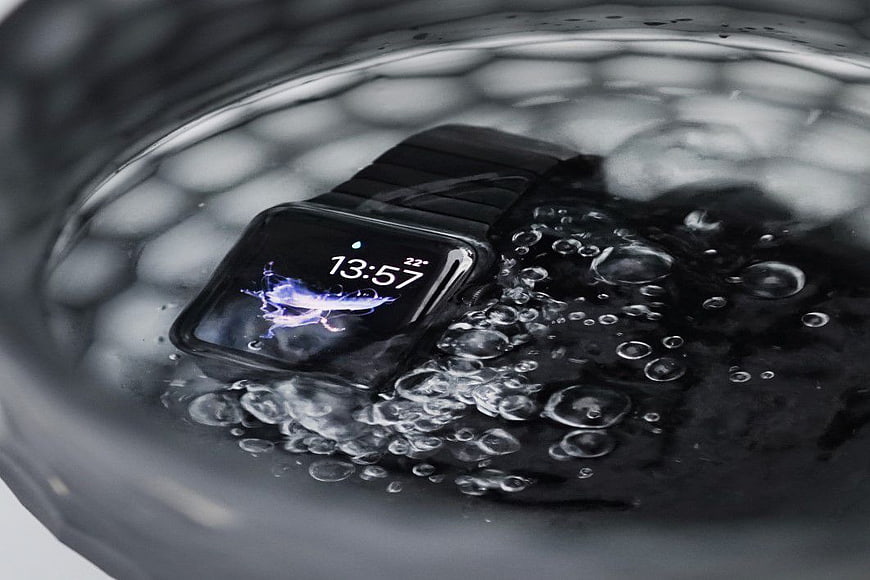 Black Smartwatch Submerged in Water with Bubbles