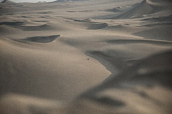 Aerial View of Sand Dunes with ATV Tracks in Desert