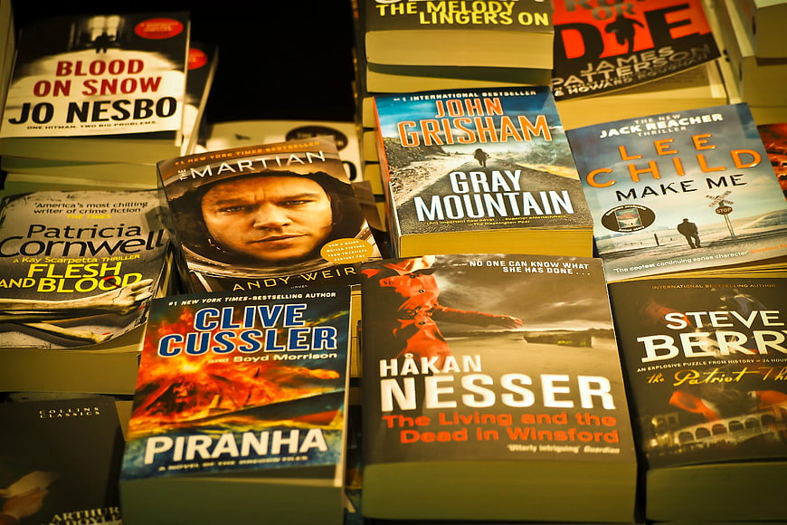 Stacks of bestselling thriller novels on bookstore shelf