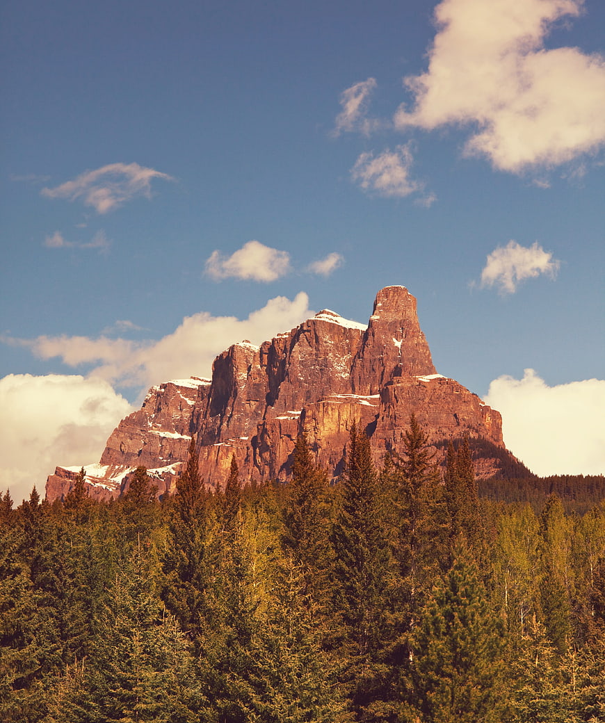 Majestic Red Rock Mountain Peak with Snow and Forest