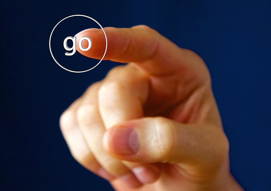 Finger Pressing Go Button On Dark Blue Background