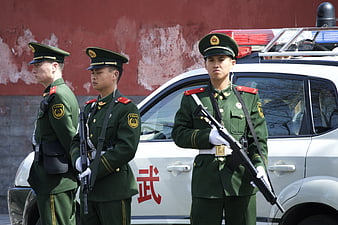 Chinese Military Police Standing Guard in Green Uniforms