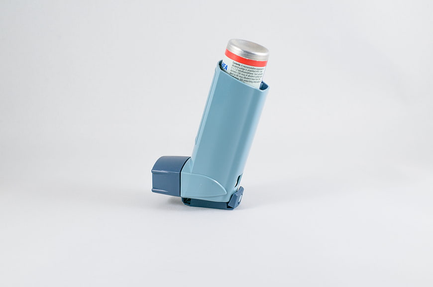 Blue Asthma Inhaler on White Background