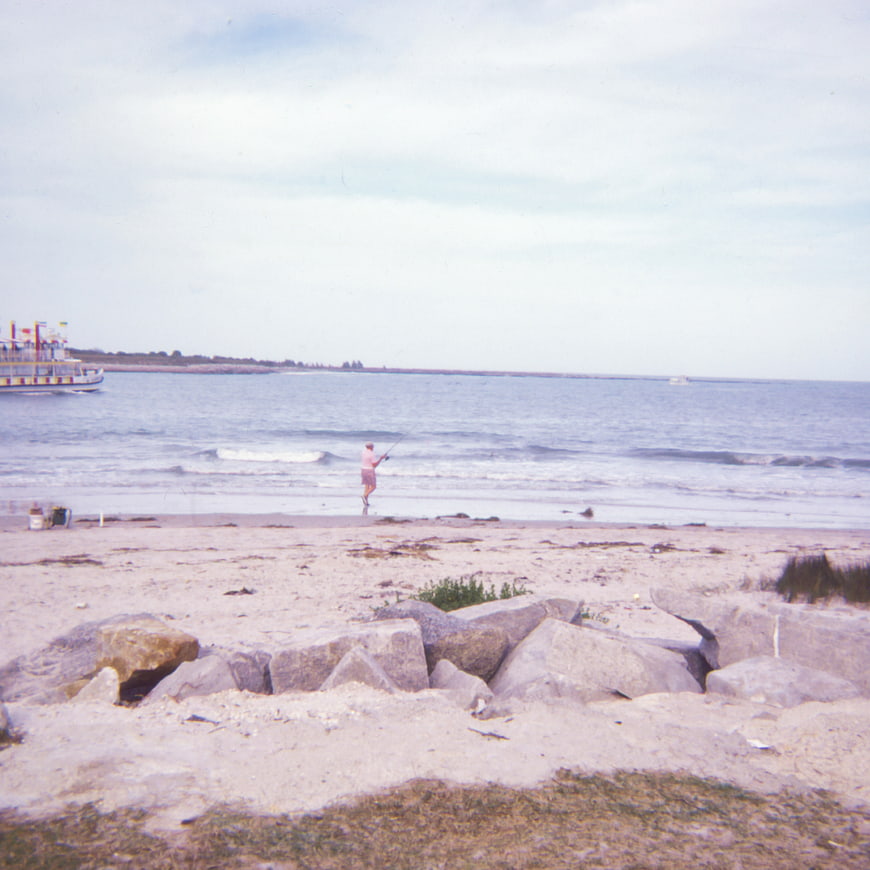 Vintage Film Photo of Fisherman on Sandy Beach