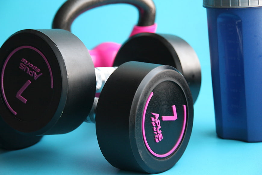 Black Dumbbells And Blue Shaker Bottle On Cyan Background