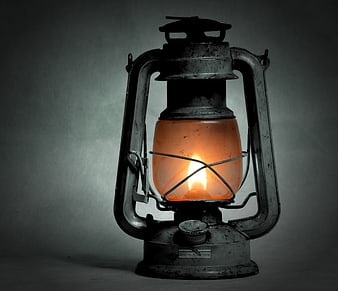 Vintage Kerosene Lantern with Glowing Flame on Dark Background