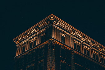 Low angle view of ornate building corner at night