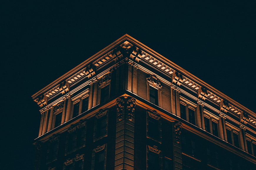 Low angle view of ornate building corner at night