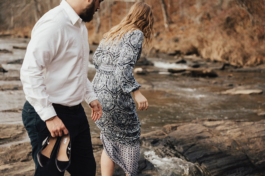 Couple Walking by River in Formal Attitude