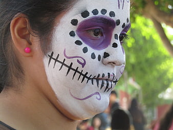 Close-up of woman with Day of the Dead sugar skull face paint
