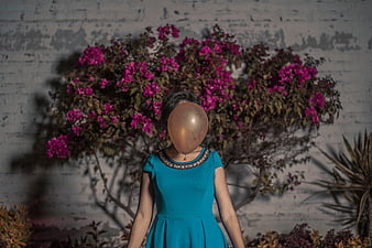 Woman with Gold Balloon for Head in Blue Dress