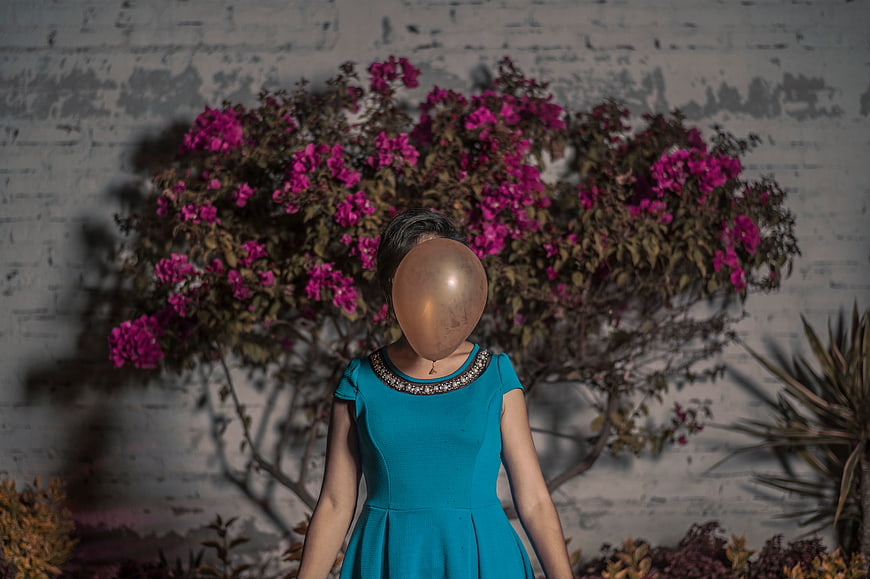 Woman with Gold Balloon for Head in Blue Dress