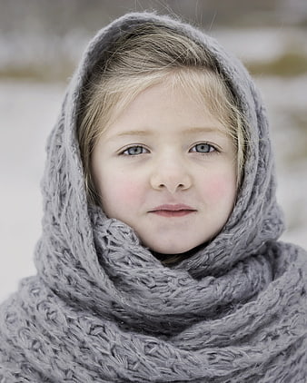 Portrait of a young girl in a gray winter scarf