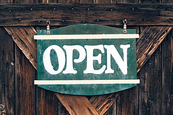 Vintage Green Open Sign on Rustic Wooden Barn Door