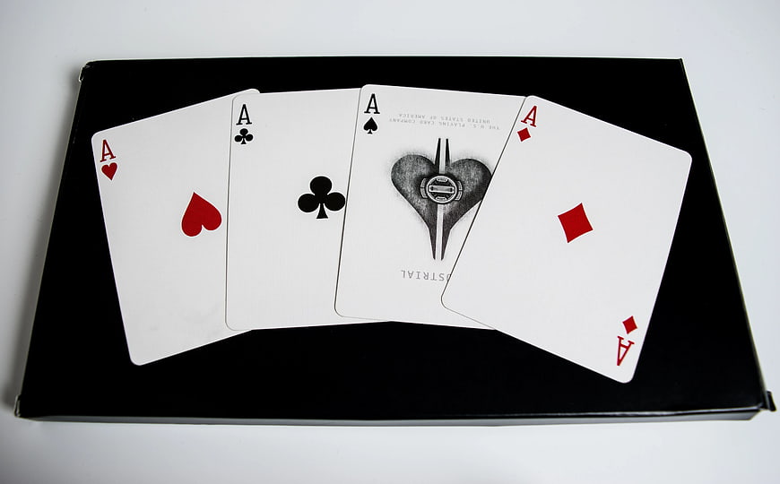 Four Aces Playing Cards on Black Box