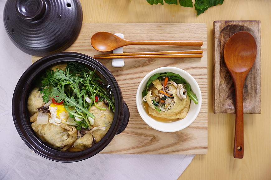Korean Fish Cake Soup with Egg and Greens on Wooden Board