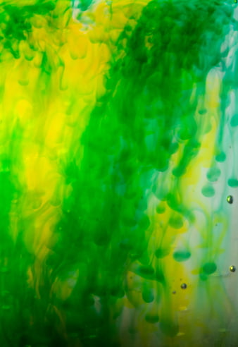 Abstract Green and Yellow Ink Swirls in Water