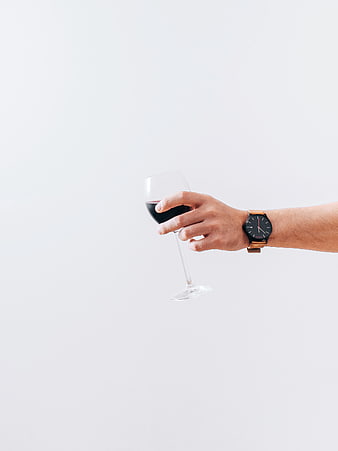 Hand Holding Red Wine Glass with Watch on White Background