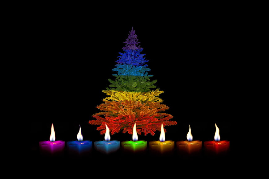 Rainbow Christmas Tree with Colorful Candles on Black Background