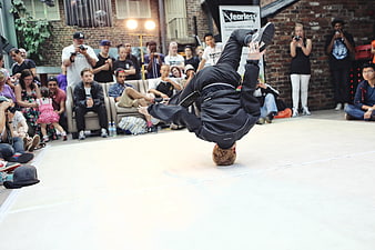 Breakdancer performing headspin move at urban street dance battle