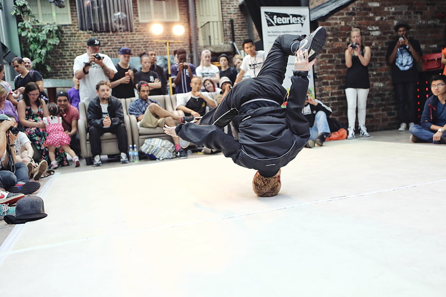 Breakdancer performing headspin move at urban street dance battle