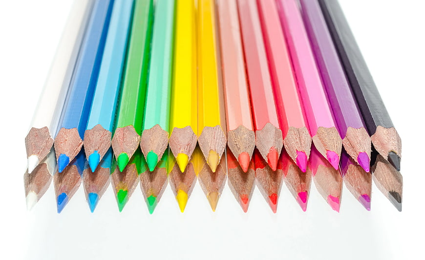 Row of colorful pencils on white background