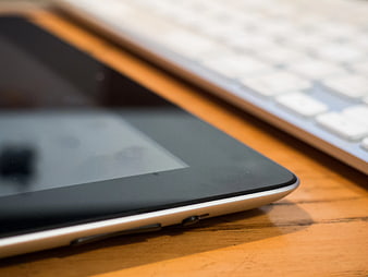 Close-up of Tablet and Keyboard on Wooden Desk