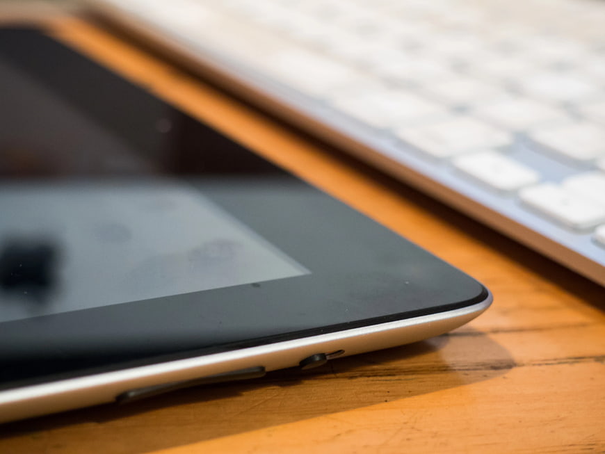 Close-up of Tablet and Keyboard on Wooden Desk