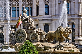 Fountain of Cybele with Lions and Spanish Flag in Madrid