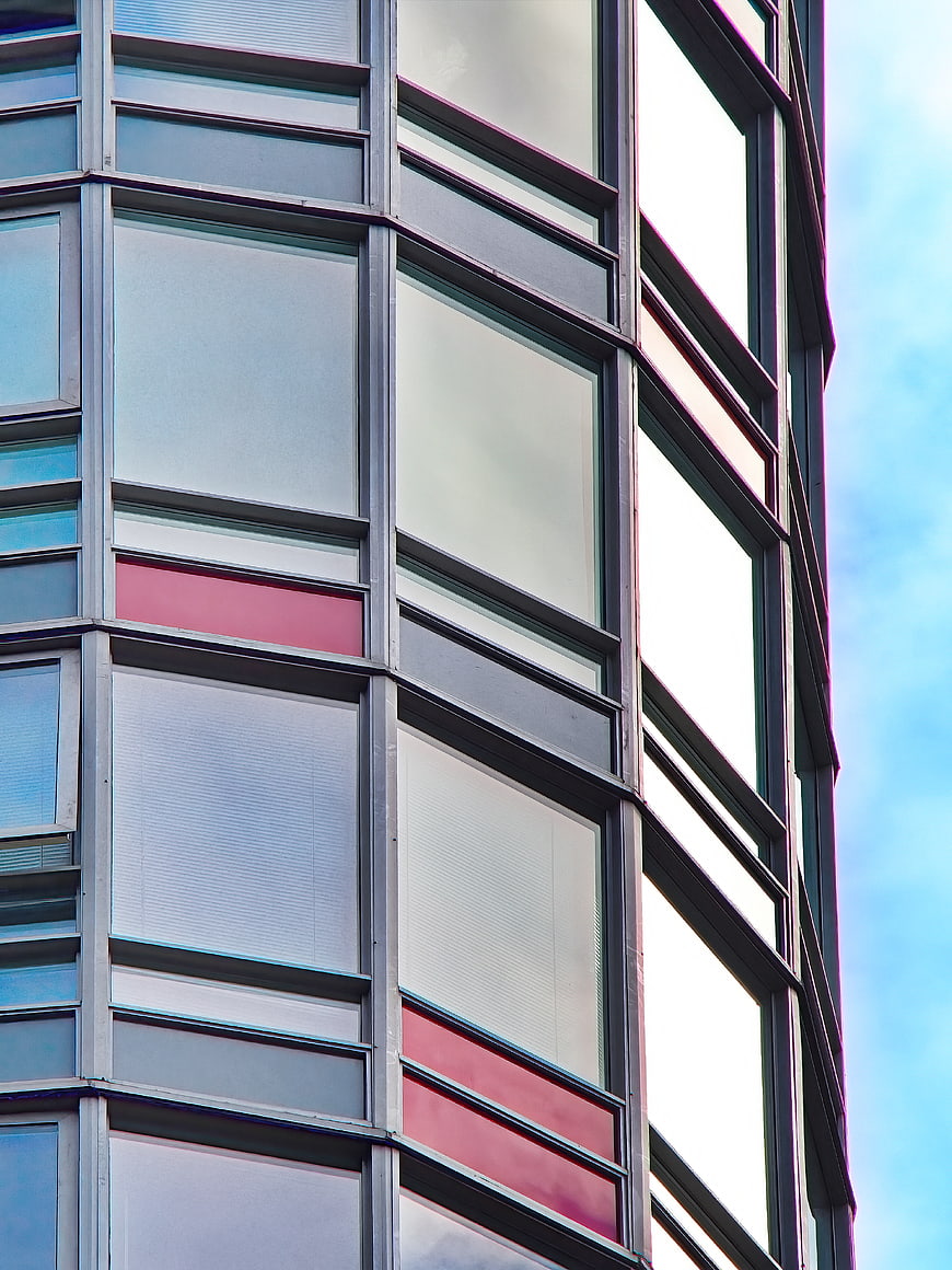 Modern Glass Office Building Facade with Red Accents